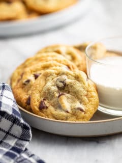 Chocolate Chip Pudding Cookies arranged on a plate around a glass of milk