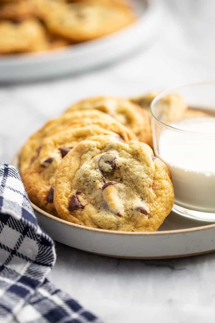 Chocolate Chip Pudding Cookies arranged on a plate around a glass of milk