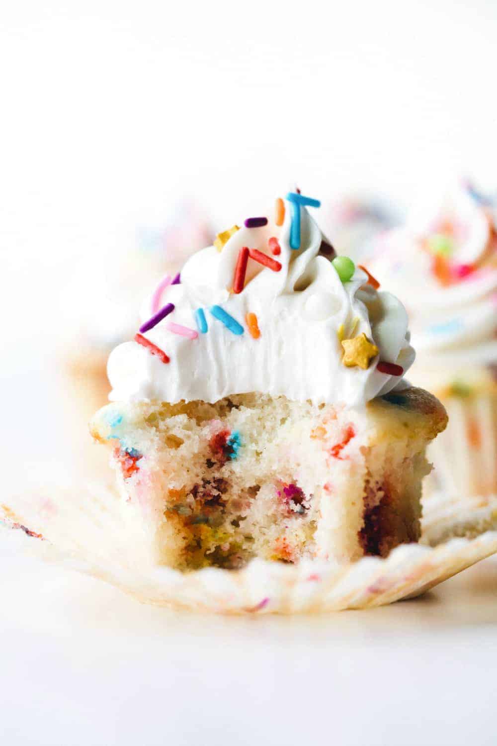 Funfetti cupcake with a bite taken out of it