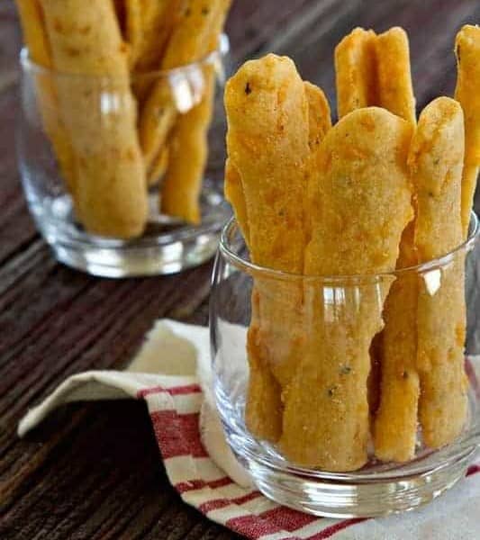 Cheese straws come together in a snap and are just perfect for just about any party. Garlic and rosemary give them a little unexpected kick.