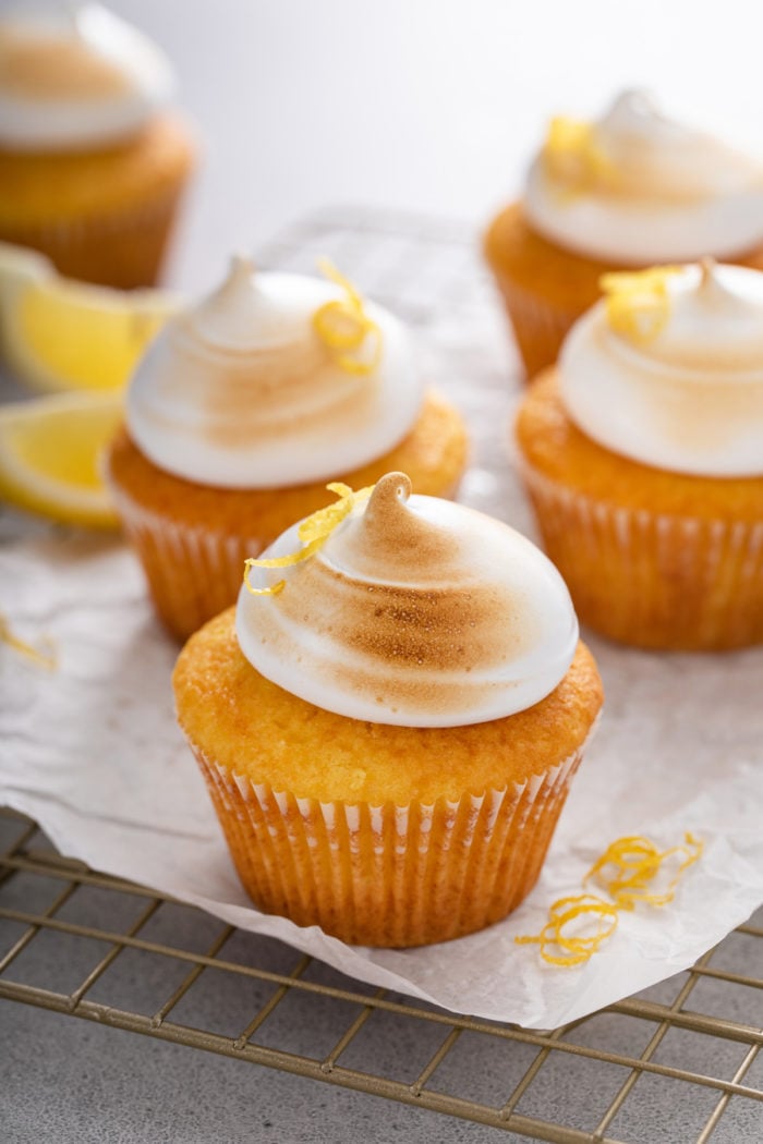 Several cupcakes topped with toasted marshmallow frosting.