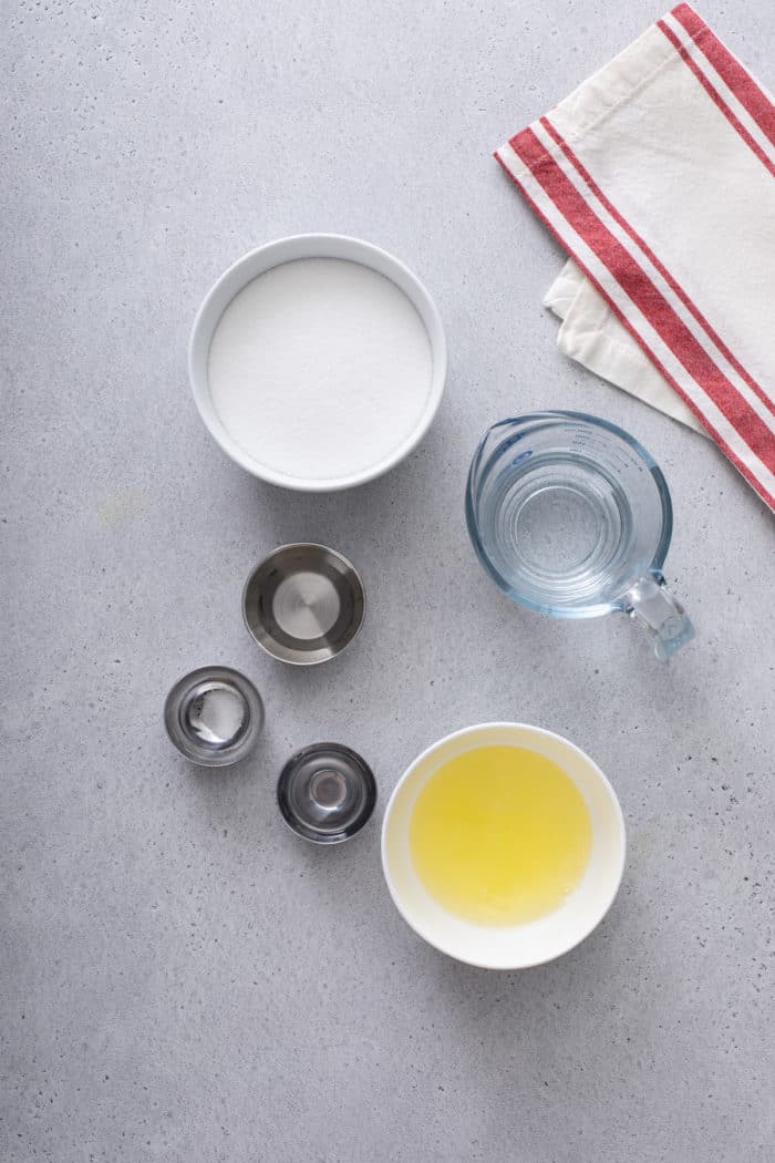 Ingredients for marshmallow frosting arranged on a gray countertop.