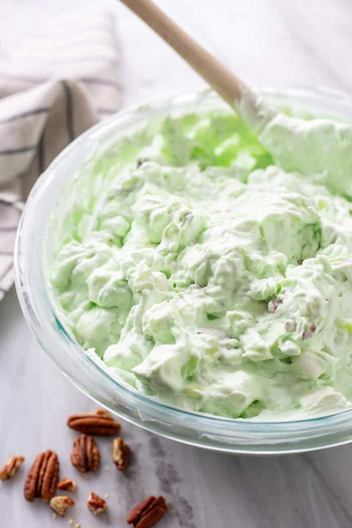 Watergate salad in a glass mixing bowl, ready to chill in the refrigerator