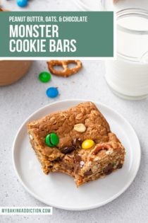 Plated monster cookie bar with a bite taken out of it. A glass of milk is in the background. Text overlay includes recipe name.