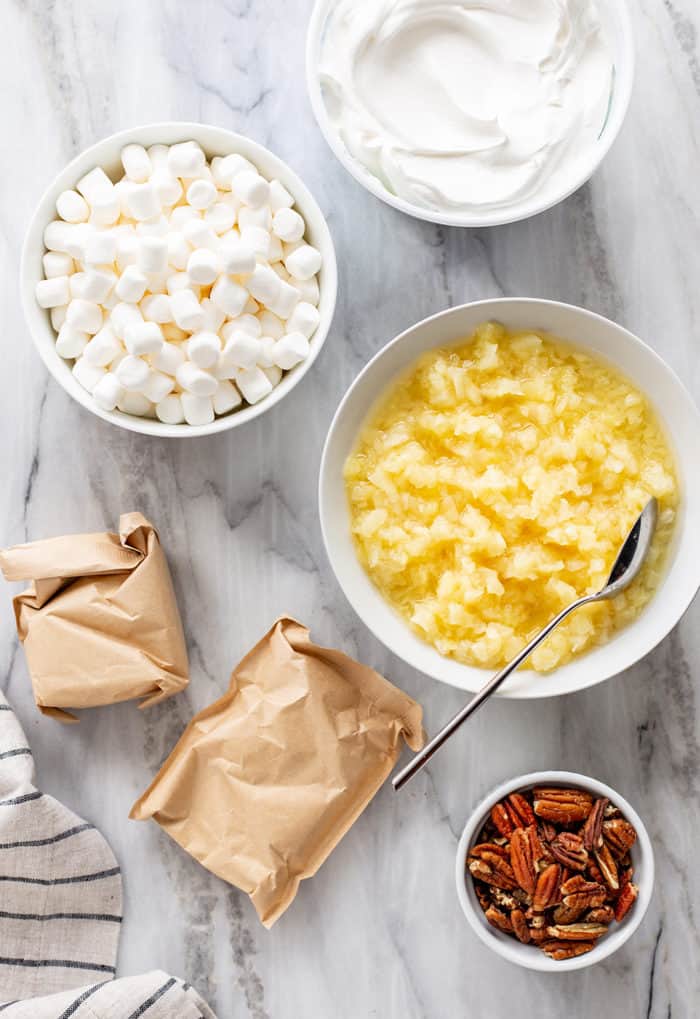 Watergate salad ingredients arranged on a marble counter