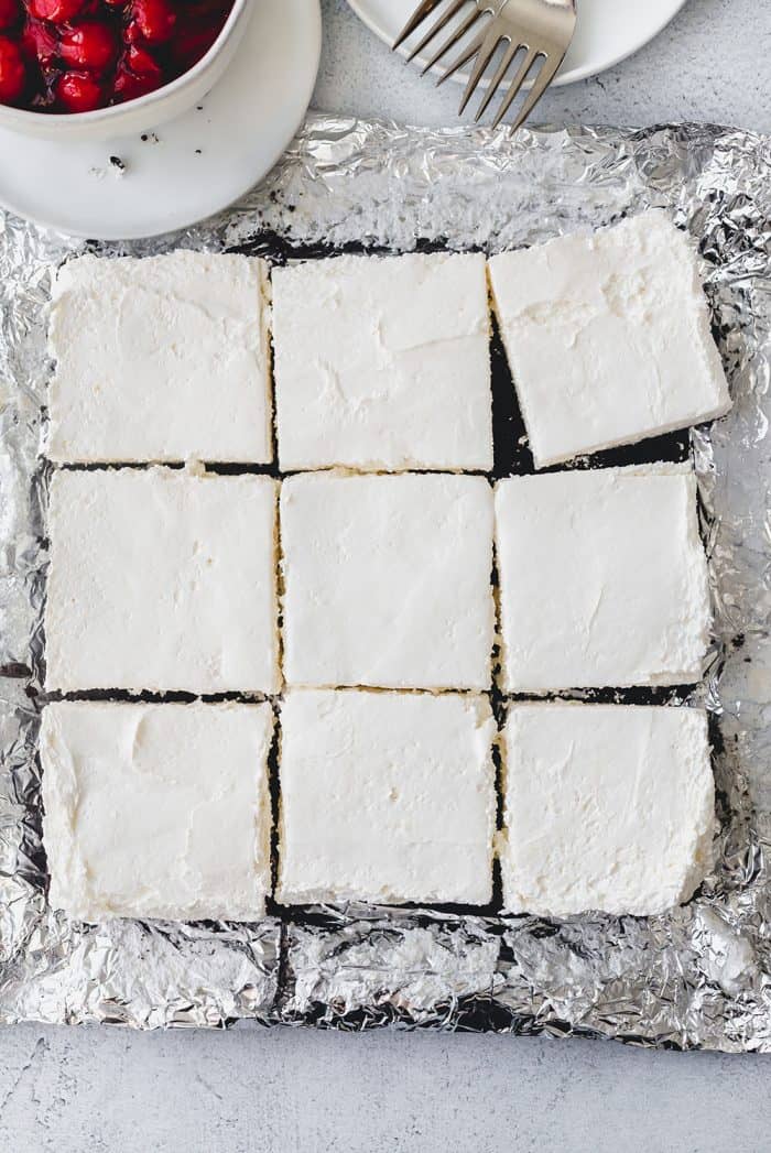 Overhead view of no bake oreo cheesecake cut into 9 squares