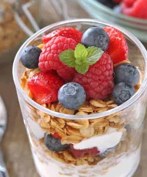 Delicious gluten-free granola pairs perfectly with fresh berries and Greek yogurt to create simple breakfast.