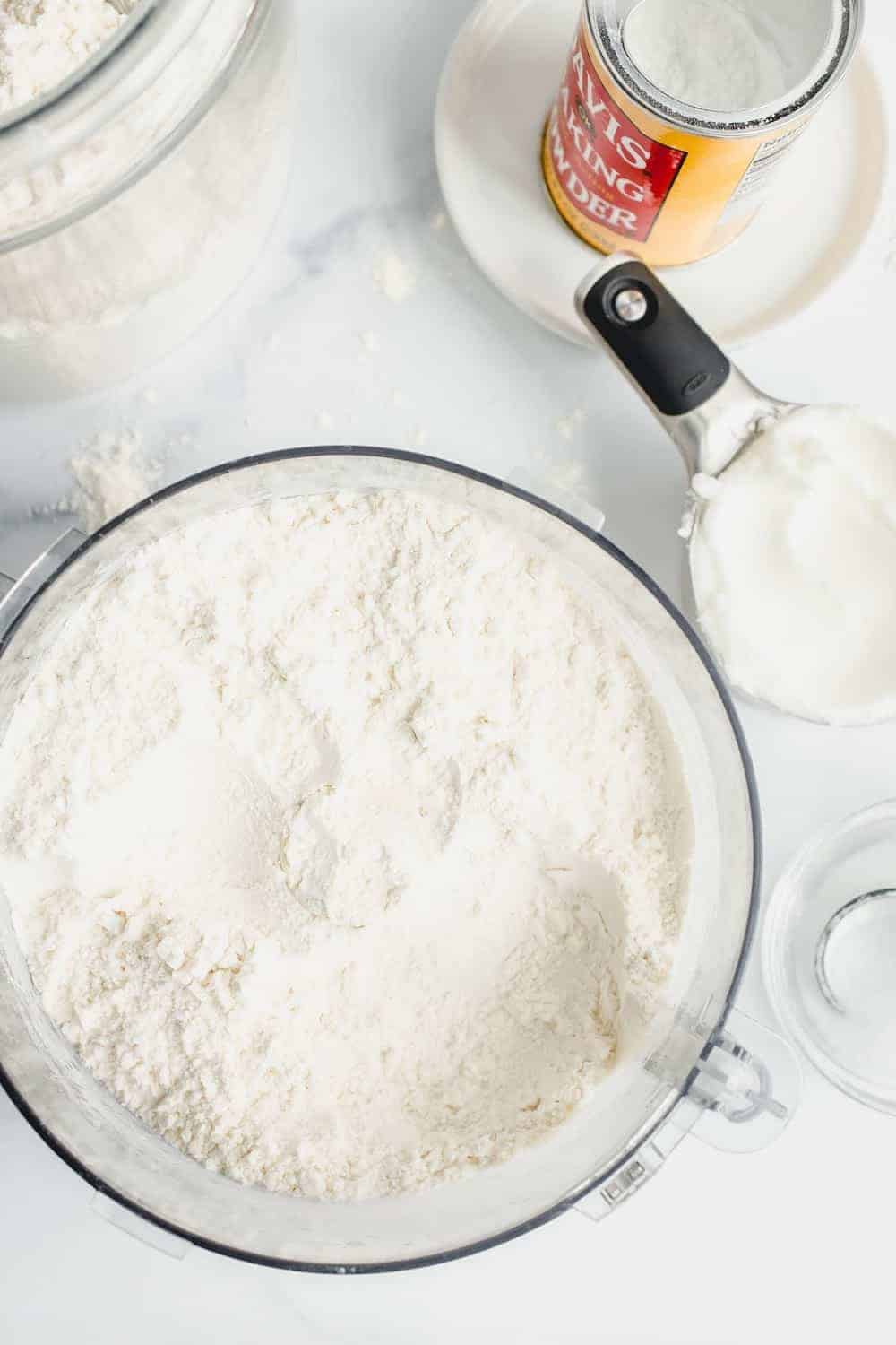 Ingredients for homemade Bisquick mix in the bowl of a food processor