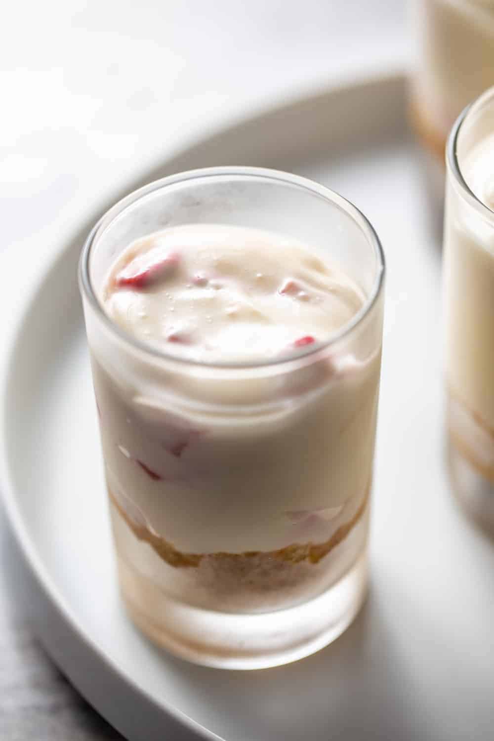 No-bake strawberry cheesecake over graham cracker crust in a small shot glass