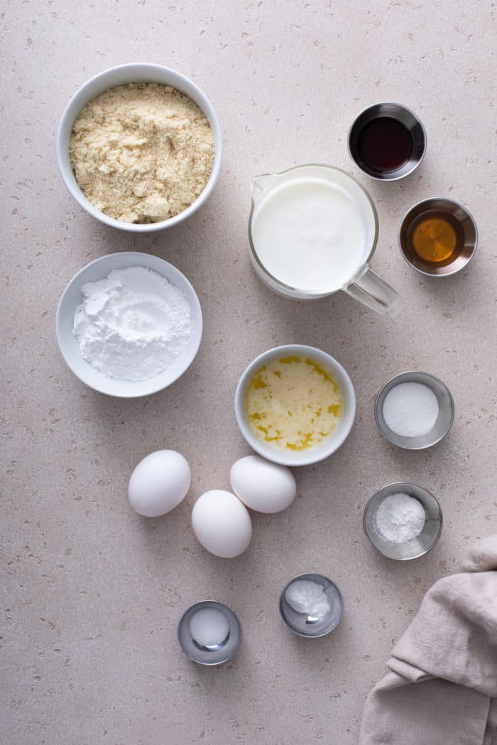 Ingredients for gluten-free pancakes arranged on a gray countertop.