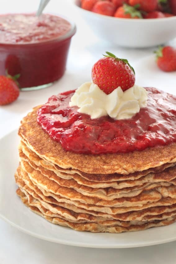 These gluten-free pancakes are almost crepe-like and are served with homemade strawberry sauce!