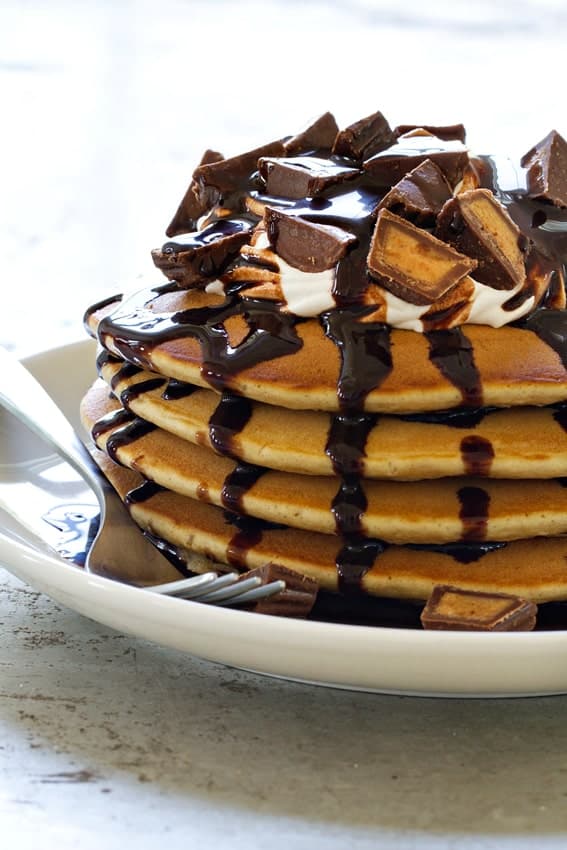 Peanut Butter Cup Pancakes offer a sweet start to your morning. Chocolate sauce and miniature peanut butter cups--what could be better?