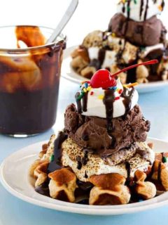 Mini waffles are topped with ice cream, toasted marshmallows and all the fixings to create the most delicious sundae.