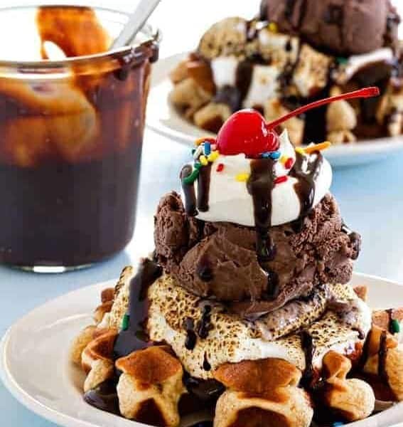 Mini waffles are topped with ice cream, toasted marshmallows and all the fixings to create the most delicious sundae.