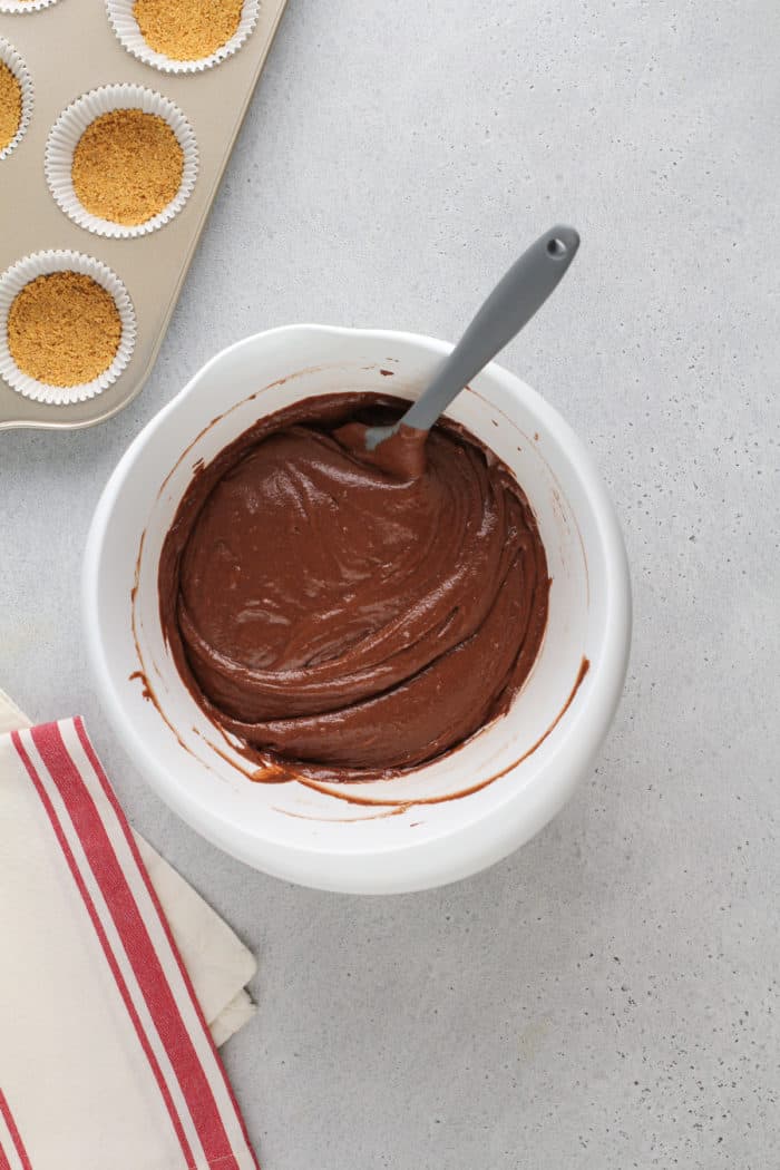 Cake batter for s'mores cupcakes in a white mixing bowl.