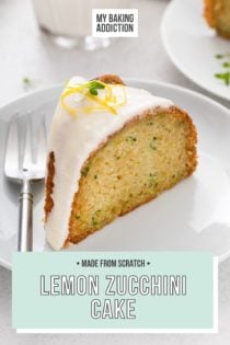 Slice of glazed lemon zucchini cake next to a fork on a white plate. A glass of milk is visible in the background. Text overlay includes recipe name.