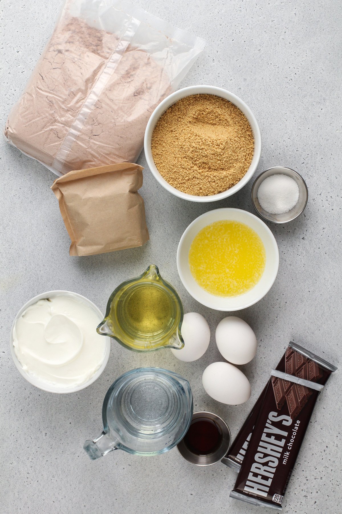 S'mores cupcake ingredients arranged on a gray countertop.