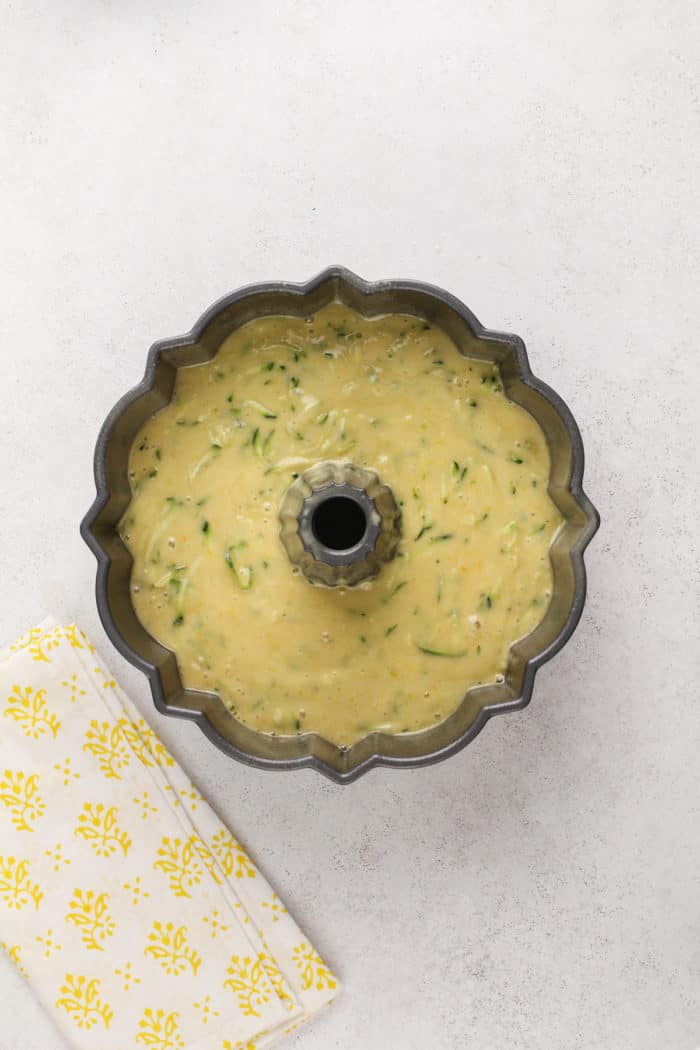 Batter for lemon zucchini cake in a bundt pan, ready to go in the oven.