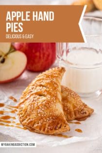 Two apple hand pies drizzled in caramel sauce, set in front of a glass of milk. Text overlay includes recipe name.
