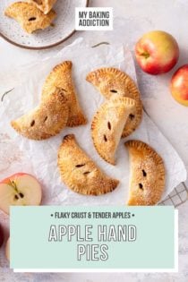 Overhead view of apple hand pies scattered on a piece of parchment paper. Text overlay includes recipe name.