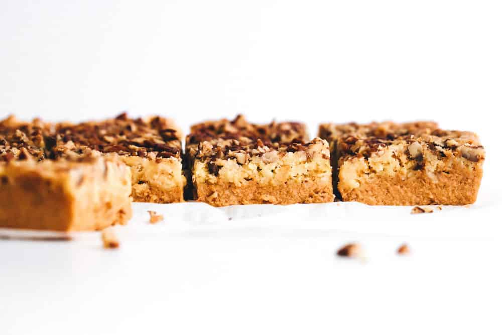 horizontal image of sliced pumpkin crunch cake with crumbs in foreground