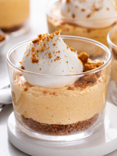 Close up of no bake pumpkin cheesecake set on a white coaster.