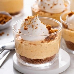 Close up of no bake pumpkin cheesecake set on a white coaster.