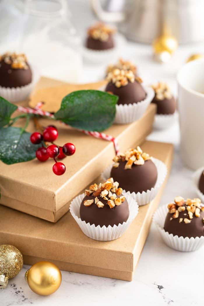 Turtle cookie balls arranged on holiday gift boxes