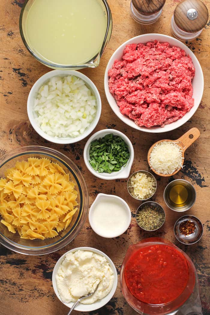 Ingredients for lasagna soup arranged on a wooden table