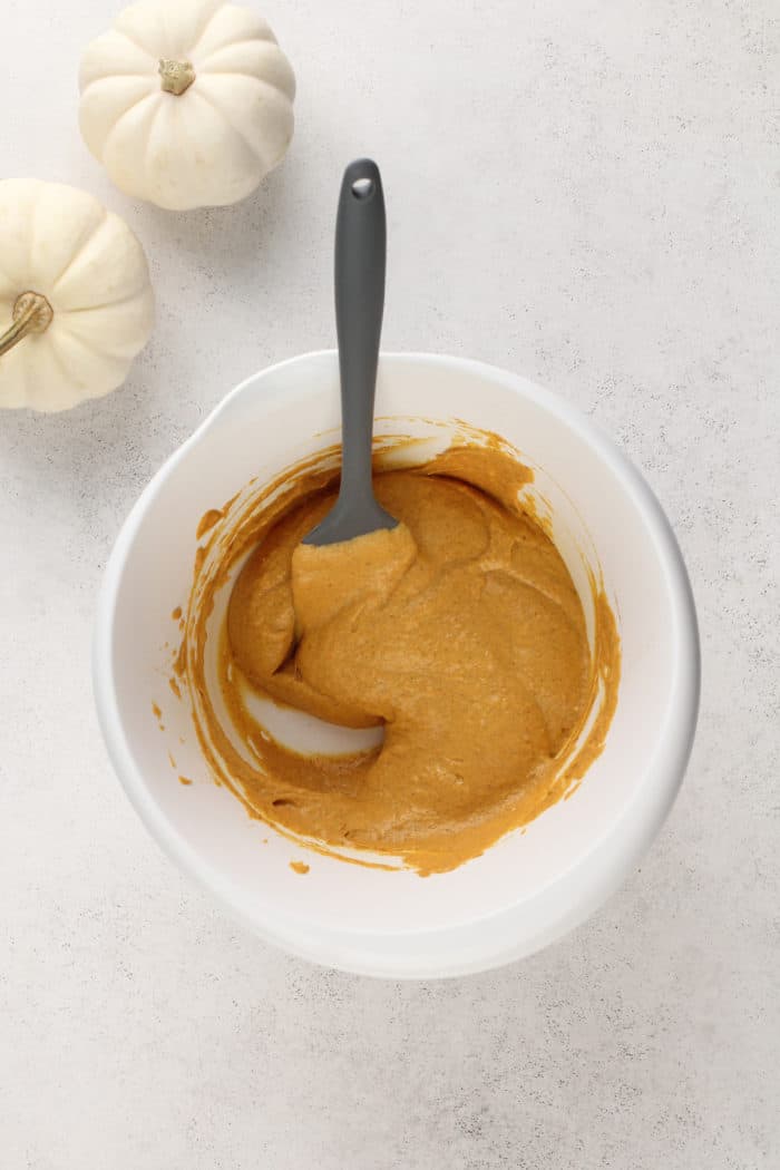 Base for pumpkin no bake cheesecake filling in a white mixing bowl.