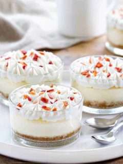 Maple Bacon Cheesecakes are the perfect sweet and salty combination. A dollop of whipped cream and candied bacon make them irresistible!