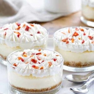 Maple Bacon Cheesecakes are the perfect sweet and salty combination. A dollop of whipped cream and candied bacon make them irresistible!