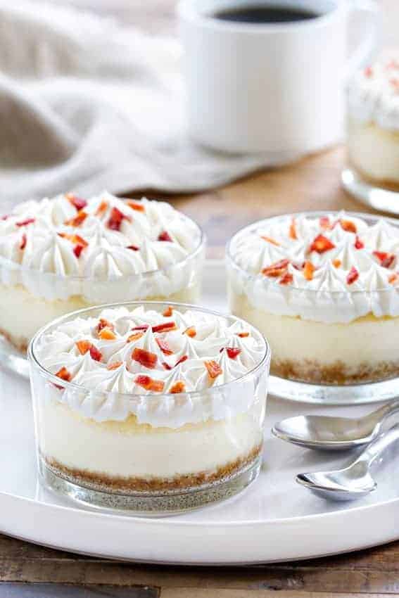Maple Bacon Cheesecakes are the perfect sweet and salty combination. A dollop of whipped cream and candied bacon make them irresistible! 
