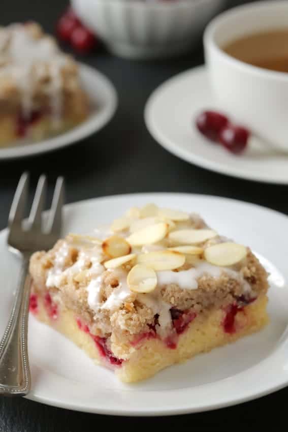 Cranberry bars with streusel and almond icing are perfect for the holidays! Recipe includes a gluten-free option.