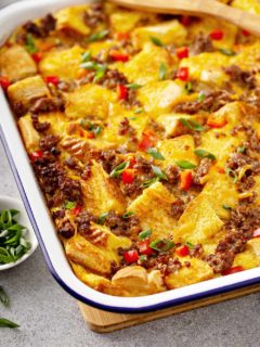 Close-up of overnight breakfast casserole in a white baking dish on a gray countertop
