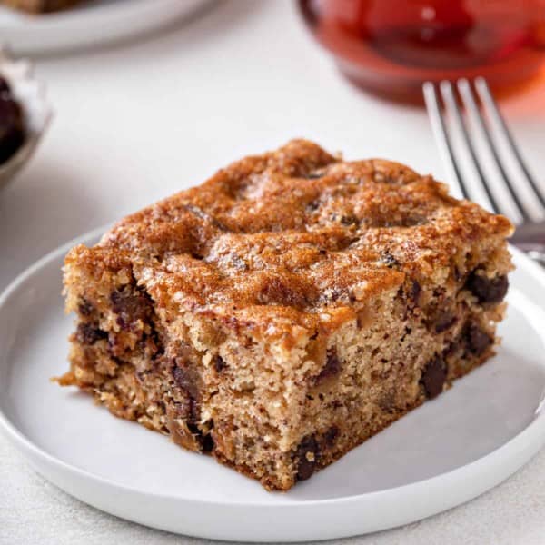 Slice of date cake on a white plate.