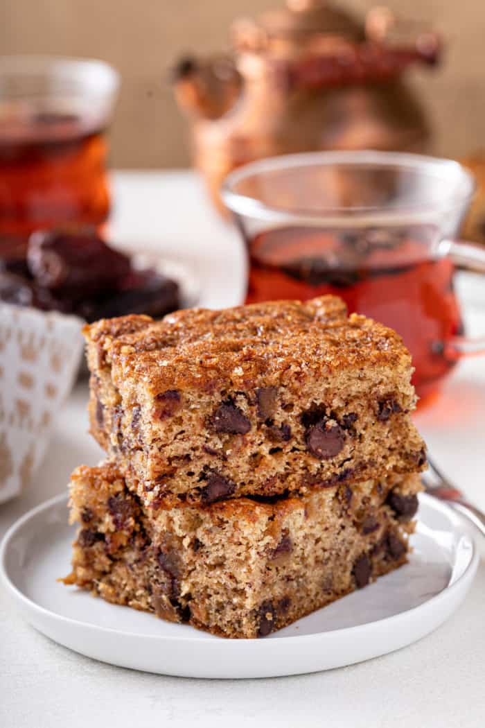 Two slices of date cake stacked on a white plate.