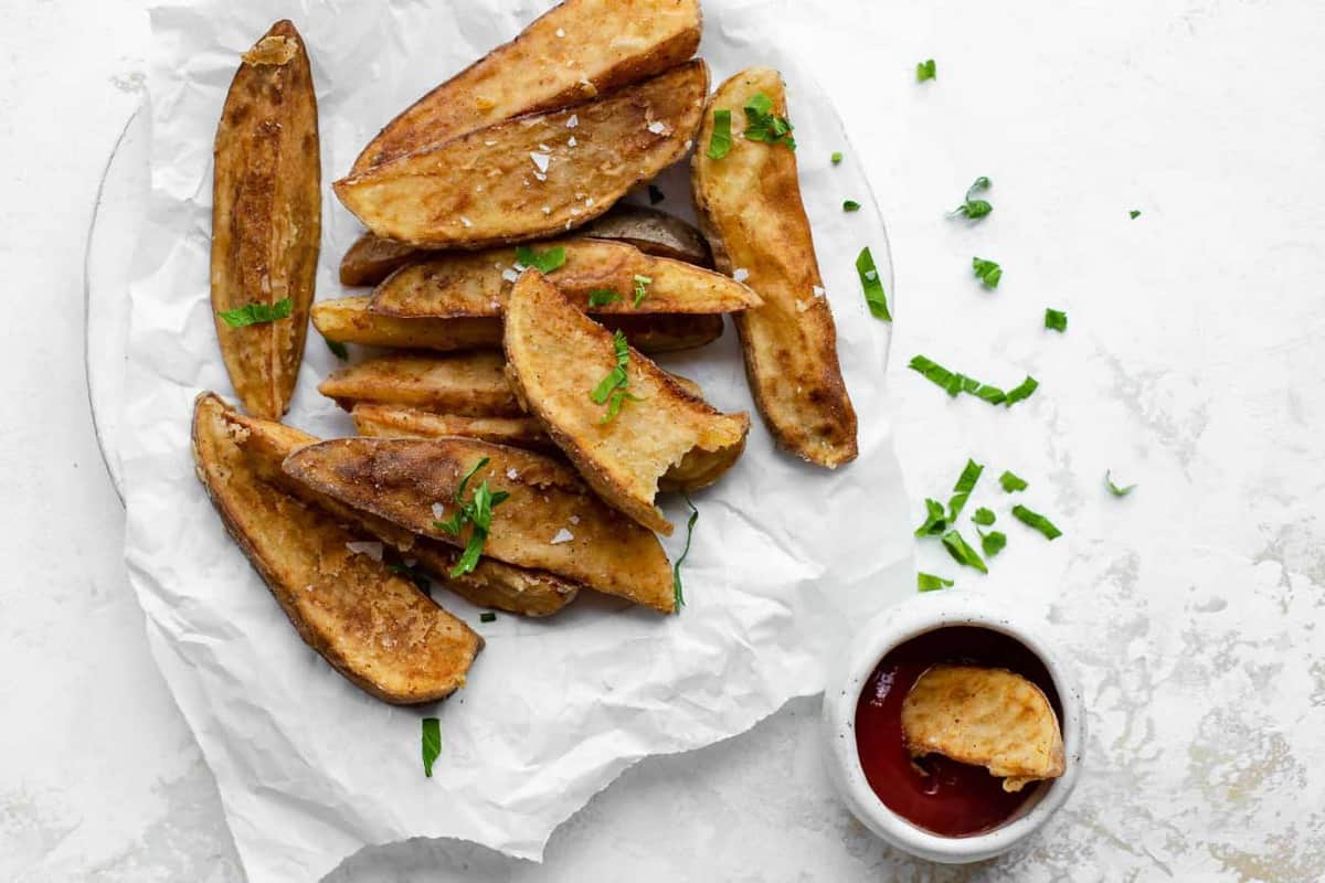 Jo Jo Potato wedges on parchment paper served with ketchup