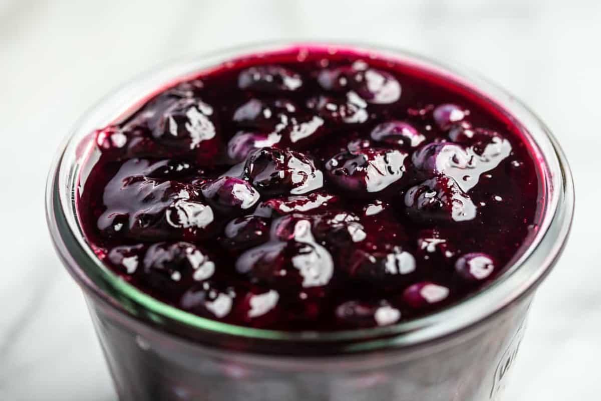 Close-up view of homemade blueberry sauce in a glass jar