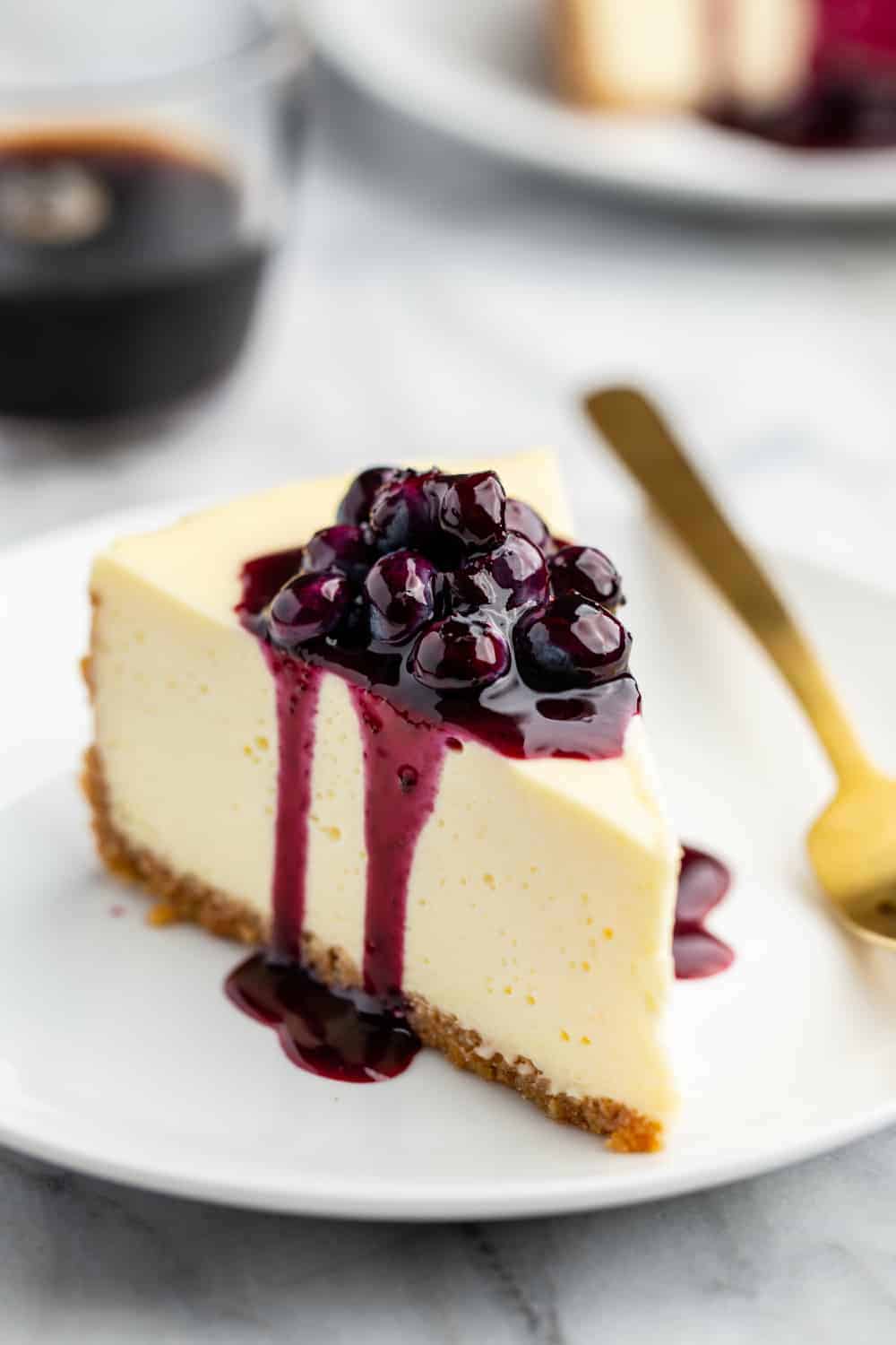 Slice of cheesecake topped with homemade blueberry sauce