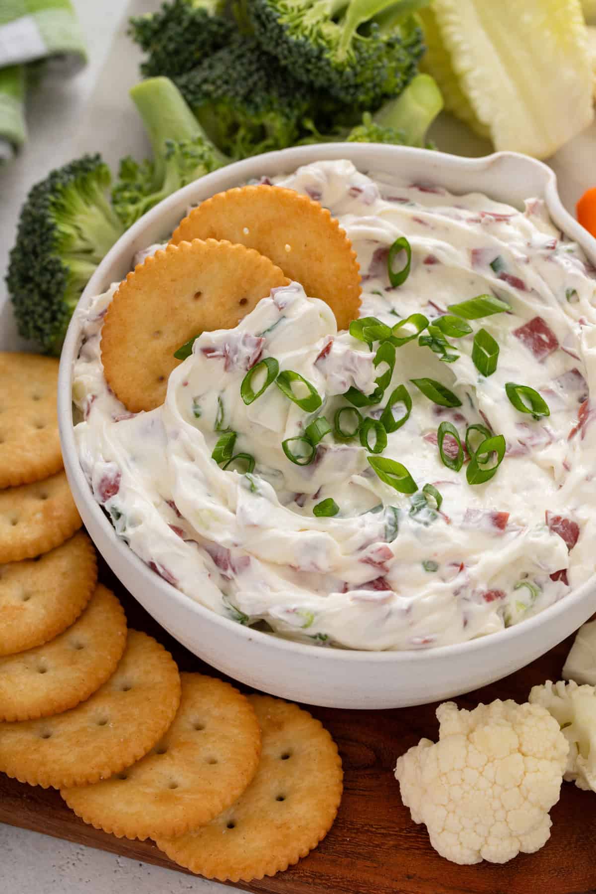 Two crackers nestled into a bowl of dried beef dip.