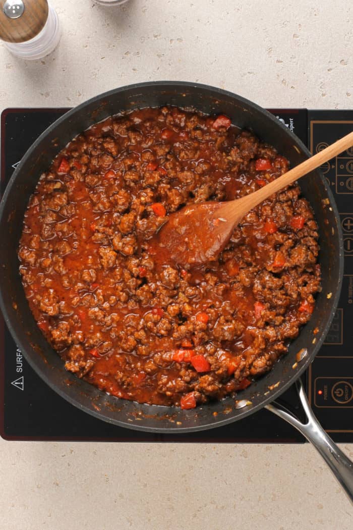 Sloppy joe mix simmering in a black skillet.