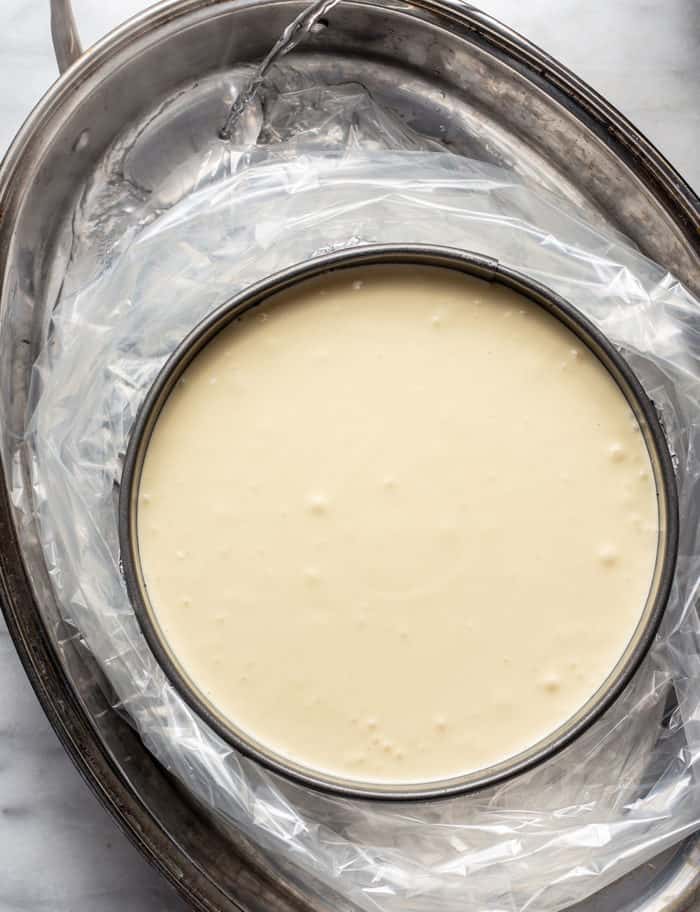 Baileys cheesecake in a water bath, ready to be baked