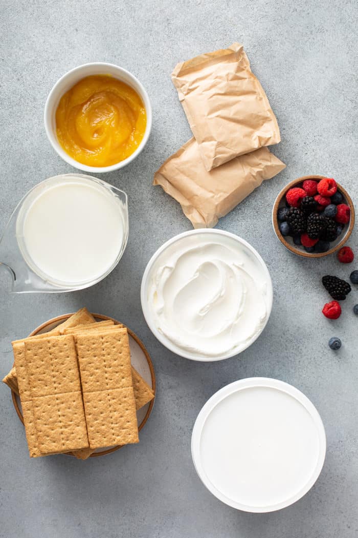 Ingredients for lemon icebox cake assembled on a gray countertop