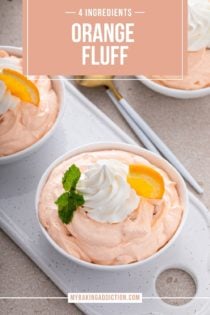 White bowl filled with orange fluff set on a white tray. Text overlay includes recipe name.