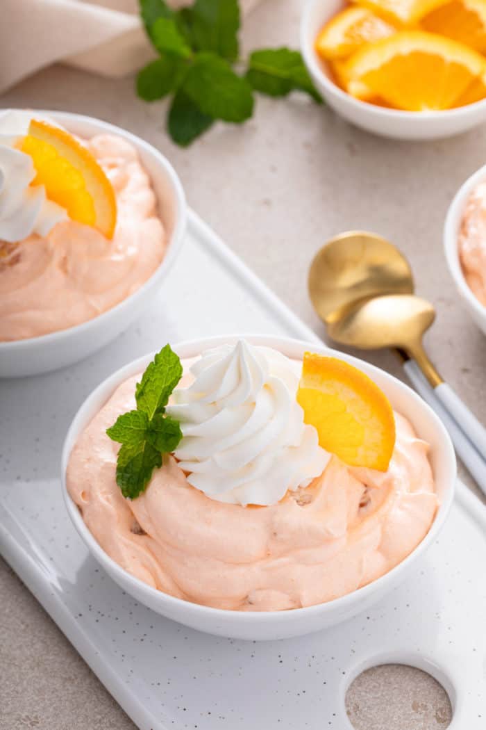 Two bowls of orange fluff set on a white tray.