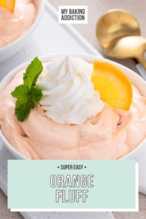 Close up of orange fluff in a white bowl, garnished with whipped cream and an orange slice. Text overlay includes recipe name.