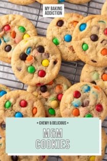 M&M cookies arranged on a wire cooling rack to cool. Text overlay includes recipe name.