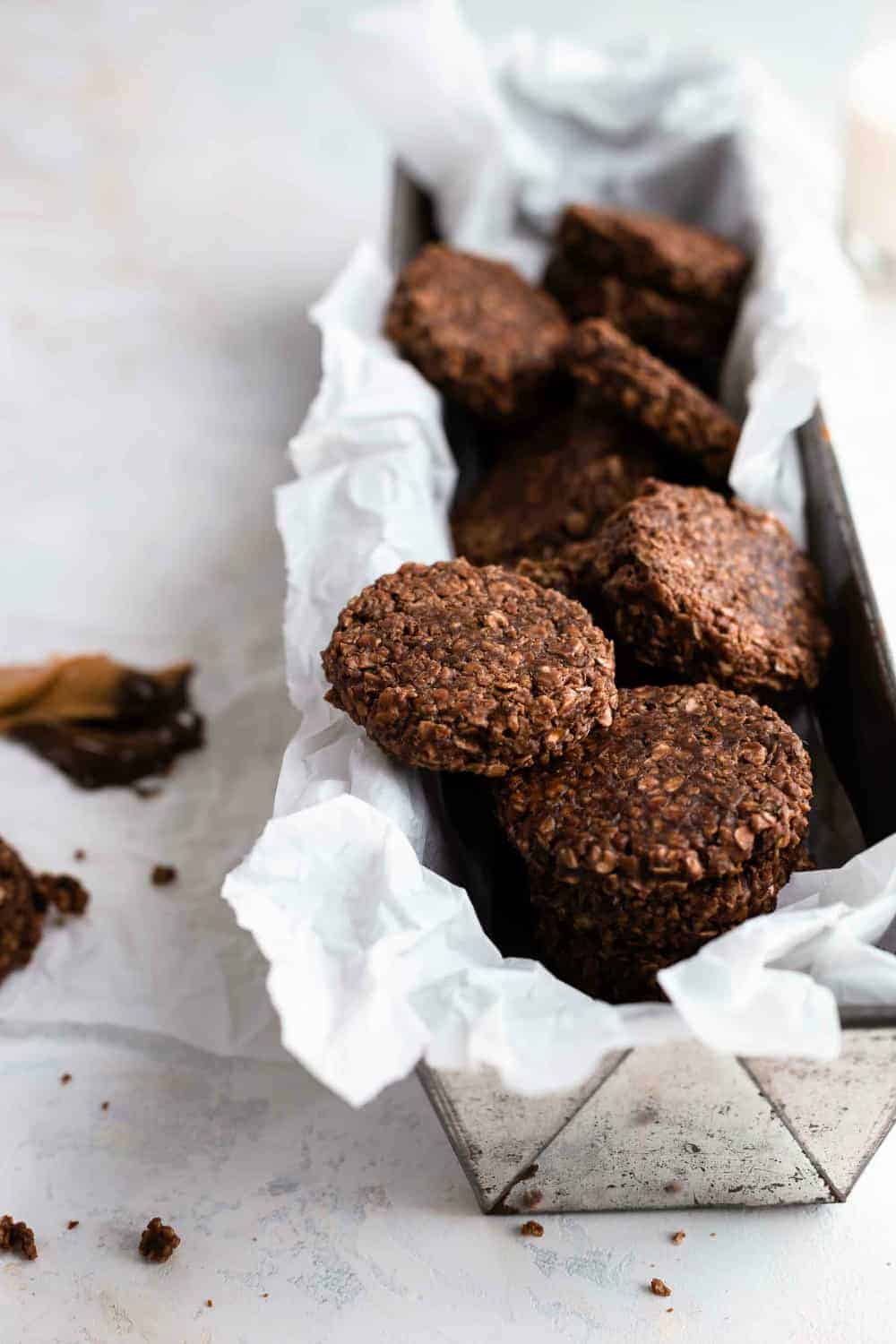 No bake cookies made from chocolate, peanut butter and oats arranged in a parchment-lined loaf pan