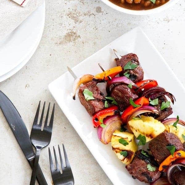 Sweet and Spicy Beef Kebabs are a delicious twist on traditional kebabs. Loaded with bell peppers, red onion, and pineapple - you'll be craving them all summer long!